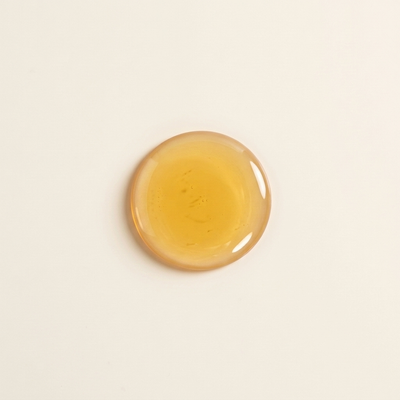 A drop of golden jojoba oil