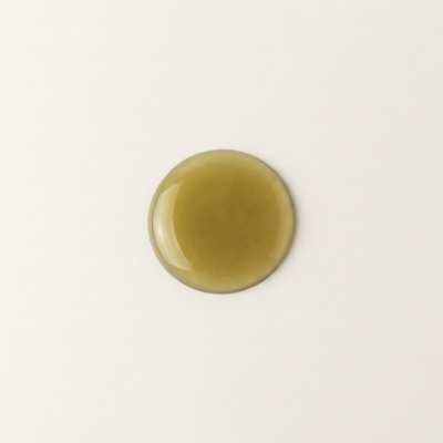 A drop of deep green tamanu oil